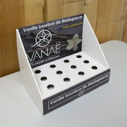 Angled Cardboard counter display with small slots/holes to hold cylindric products - printed